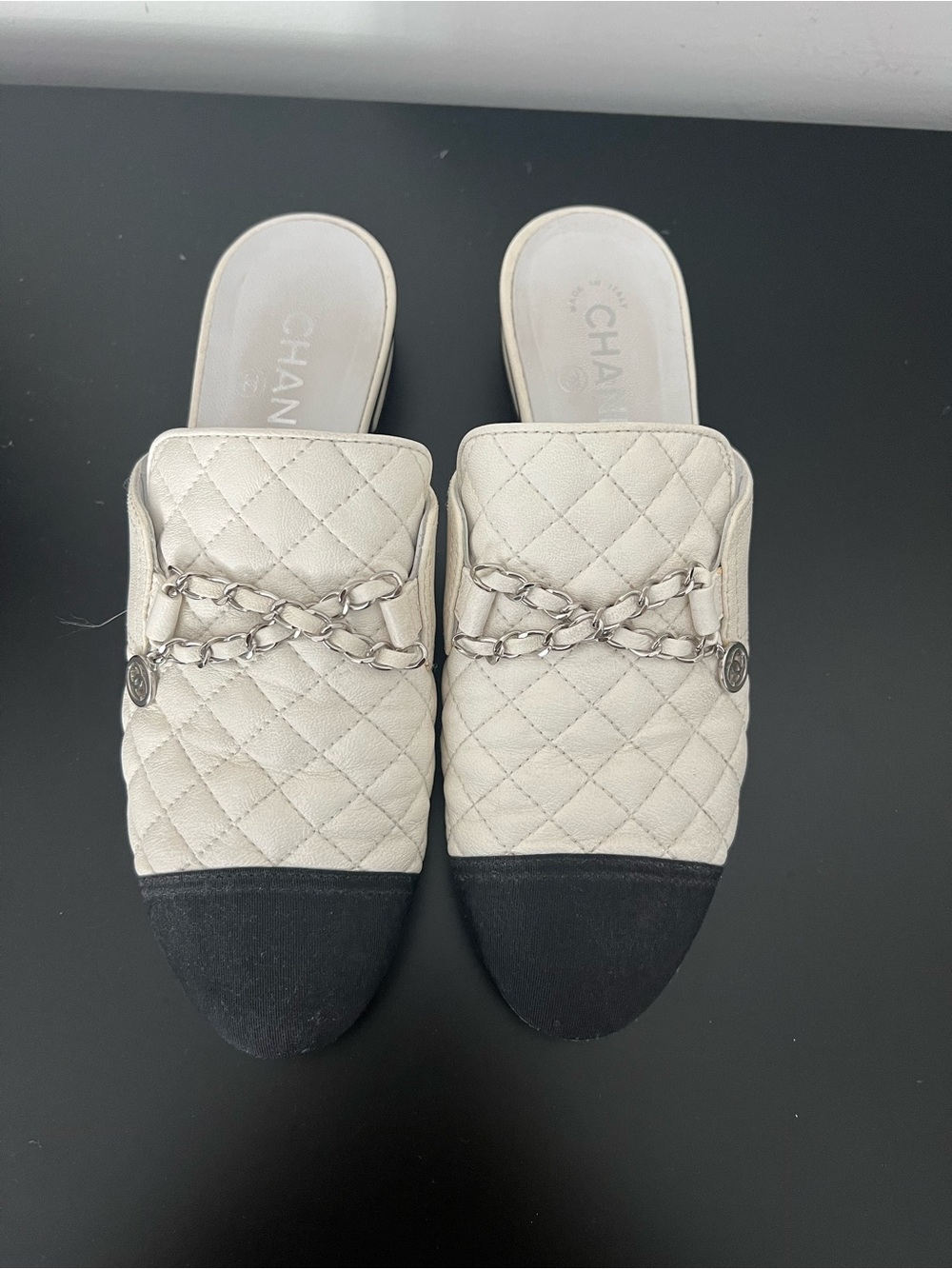 CHANEL Quilted Two-Tone Slide Mules in White and Black with Chain Detail